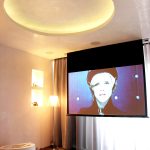 Modern cinema room with foldable screen and projector