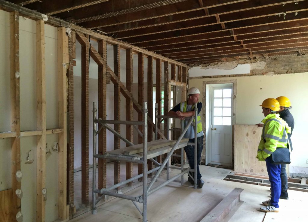 ANBM team rebuilding a wall for a house renovation project