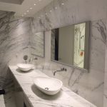 All-marble bathroom with two sinks and mirrors