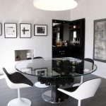 Modern dining room with glass round table and bar