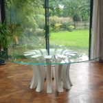 White & glass round table with garden view