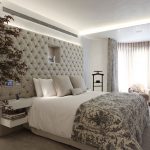 Beige master bedroom with tech-controlled upholstered headboard