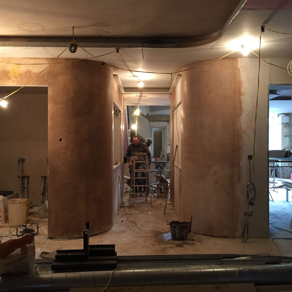 Corridor under construction with plastered walls