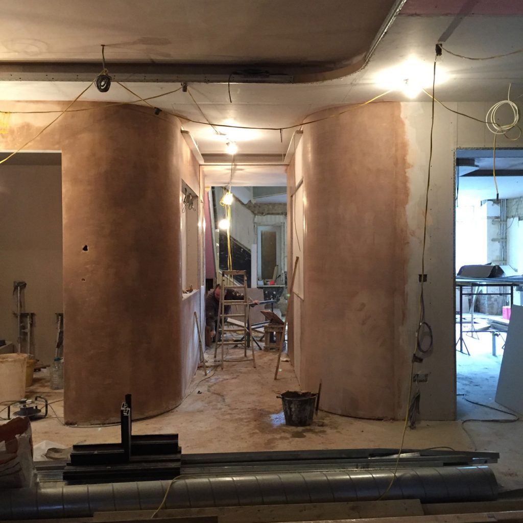 ANBM team plastering curved walls