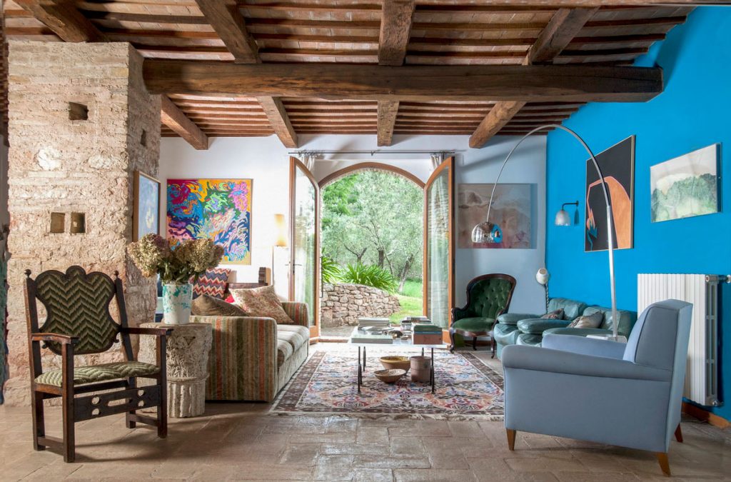 Rustic living area with exposed beams and stone floor