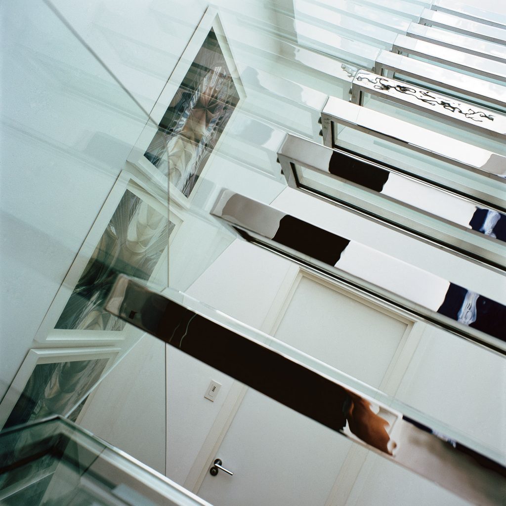 Glass staircase with chrome surrounds